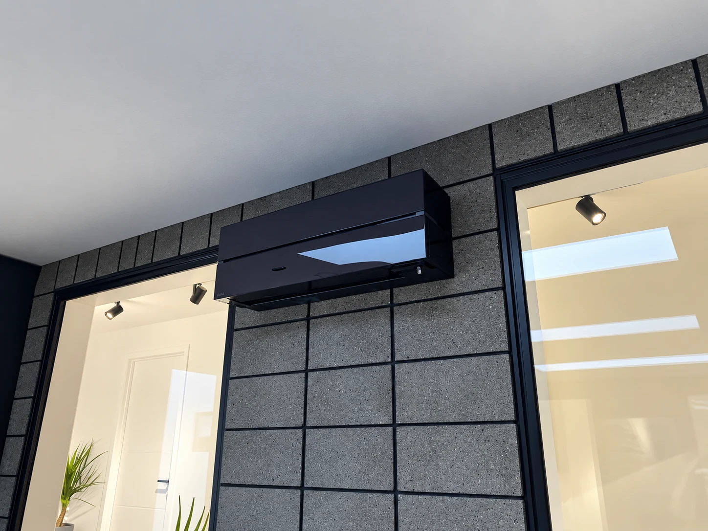 Wall-mounted heat pump installed above glazed doors